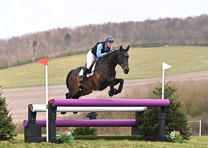 weatherbeeta sponsored rider gemma tinney jumping a horse over a cross country fence