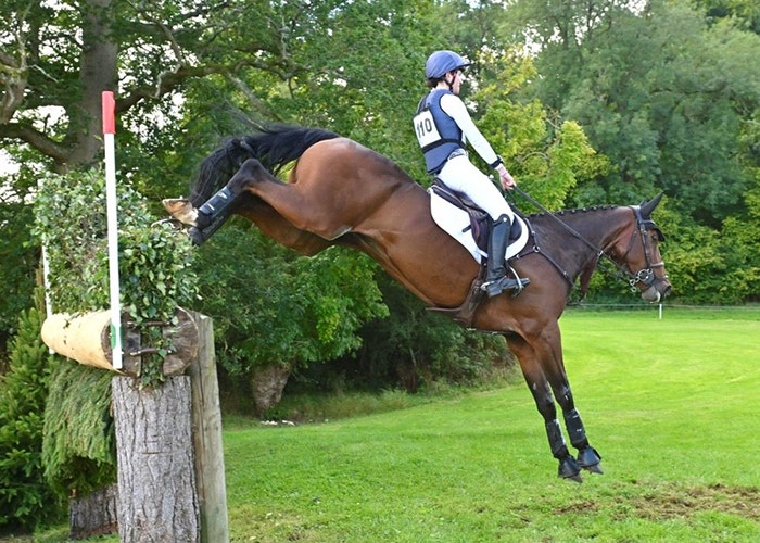 weatherbeeta sponsored rider izzy mclachlan jumping a horse over a cross country fence