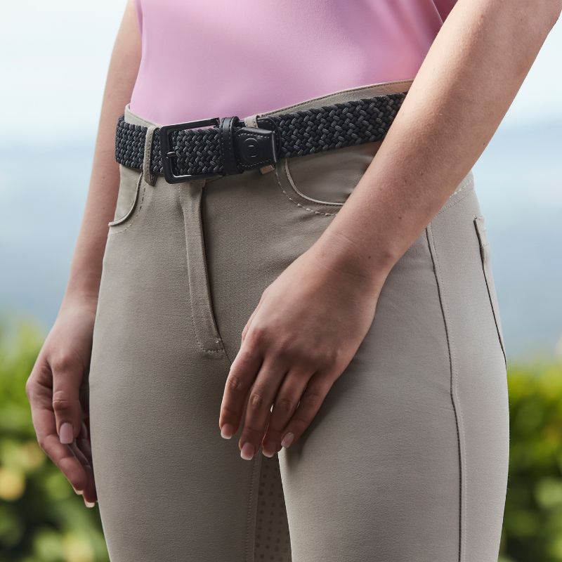 horse rider stood outside wearing beige riding breeches